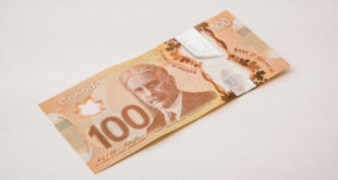 Stack of Canadian dollar banknotes showing $5, $10, $20, $50, and $100 bills