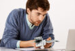 Magnifying glass searching for unclaimed money, lost funds, or hidden cash