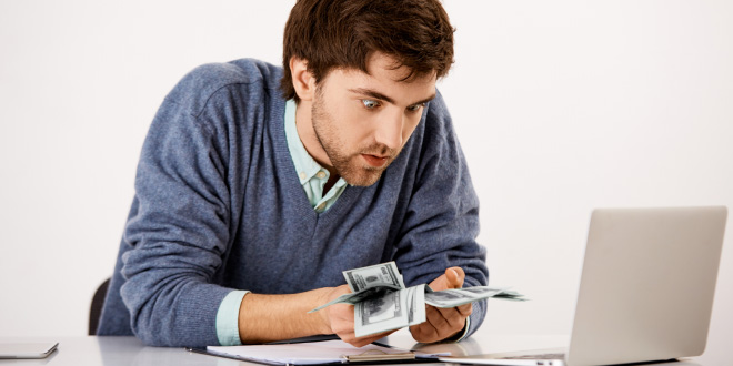 Magnifying glass searching for unclaimed money, lost funds, or hidden cash