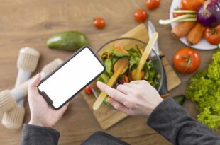 Person eagerly searching for restaurants near me on their smartphone screen showing a map interface.