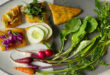 A vibrant platter showcasing a variety of delicious vegan food near me options, including a burger, salad, and pasta.