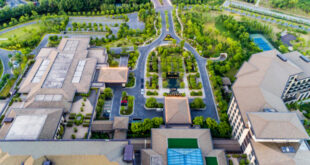 A sprawling modern apartment complexes for sale with multiple buildings and green spaces in a thriving US city.
