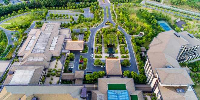 A sprawling modern apartment complexes for sale with multiple buildings and green spaces in a thriving US city.