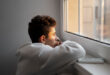 A person quietly reflecting while looking for Wint Funeral Home obits online.