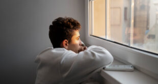 A person quietly reflecting while looking for Wint Funeral Home obits online.