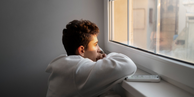 A person quietly reflecting while looking for Wint Funeral Home obits online.