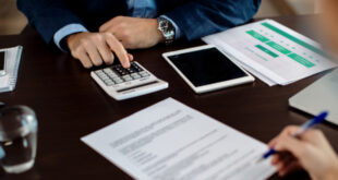 A person closely examining a document that explains what title service fees are on a closing statement.